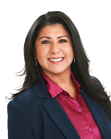How to Feel Confident in Front of the Camera (Even If You Hate Having Your Photo Taken) 1 Professional headshot of woman in front of white backdrop