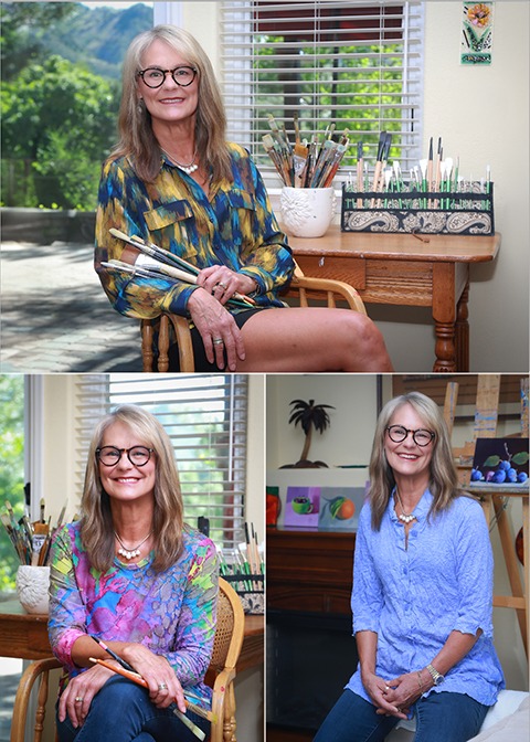 Vertical artist 3 up Artist seated in her studio holding paintbrushes, photographed for personal branding.